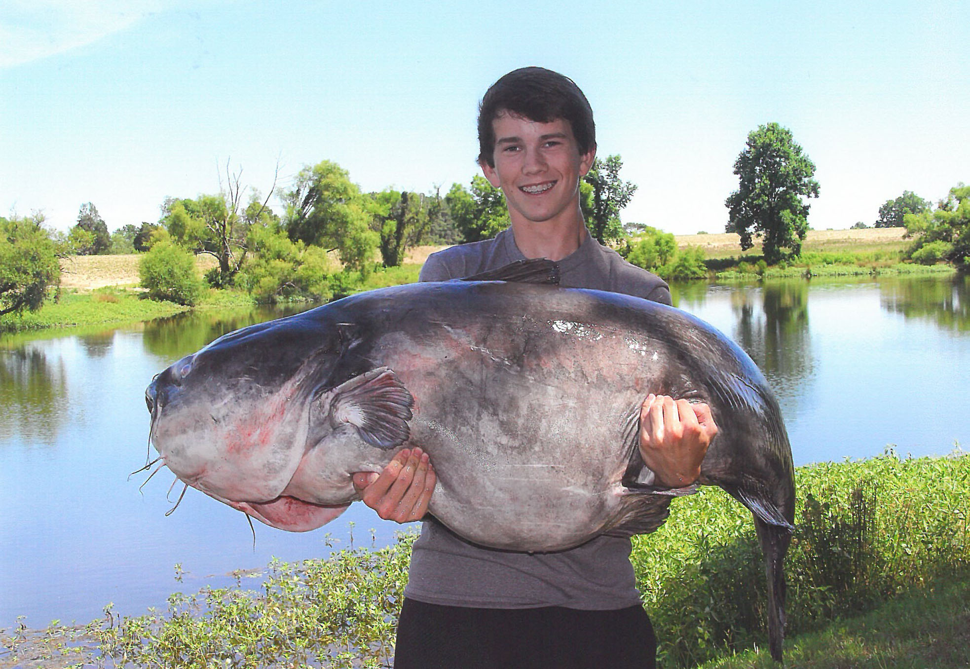 Photo Caption. Landon Evans, 15, holds the new state record for blue catfish - a 117-pound, 8 ounce fish, caught from Lake Gaston on June 11. Courtesy N.C. Wildlife Resources Commission