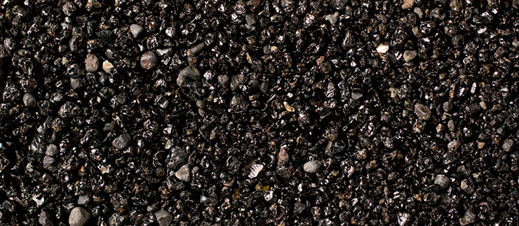 Course volcanic sand, mostly obsidian.