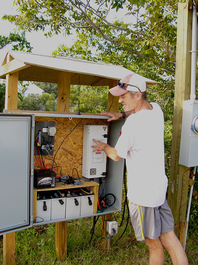 Paul Rudershausen inspects an antenna receiver inside a transceiver unit.