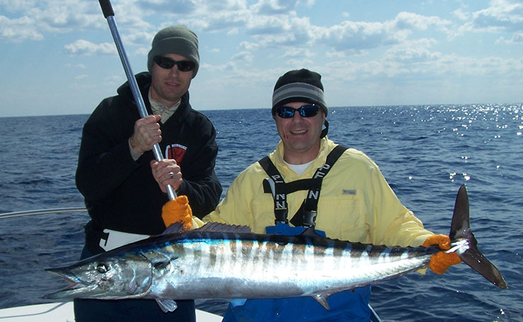 Men hold a large Atlantic wahoo.