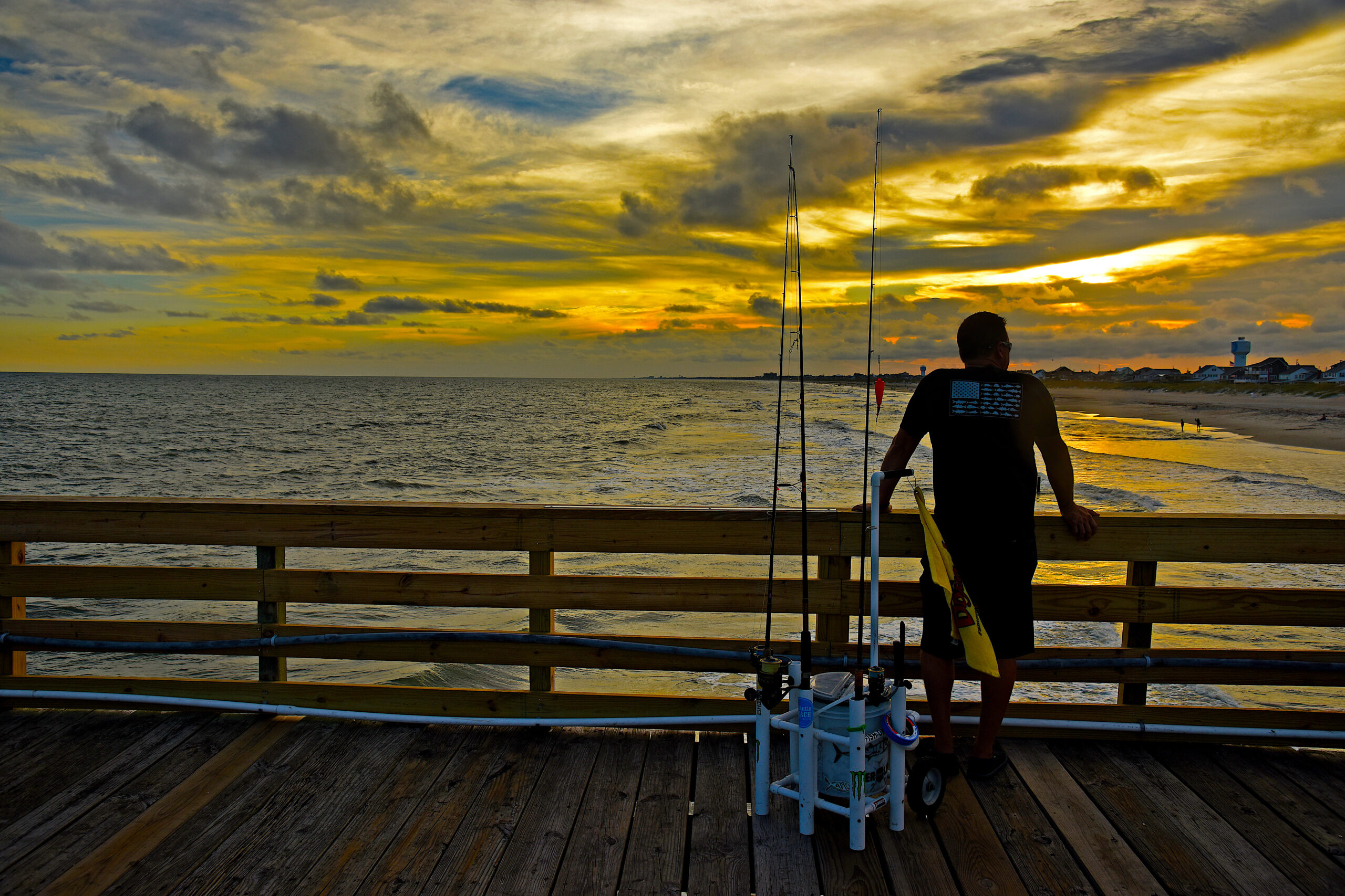 Fisherman pauses for a moment to watch the sun set from Oceanna Fishing Pier in Atlantic Beach.