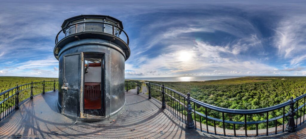image: The view from Hatteras Lighthouse with the sky and landscape in background to show the stretch off Hatteras.