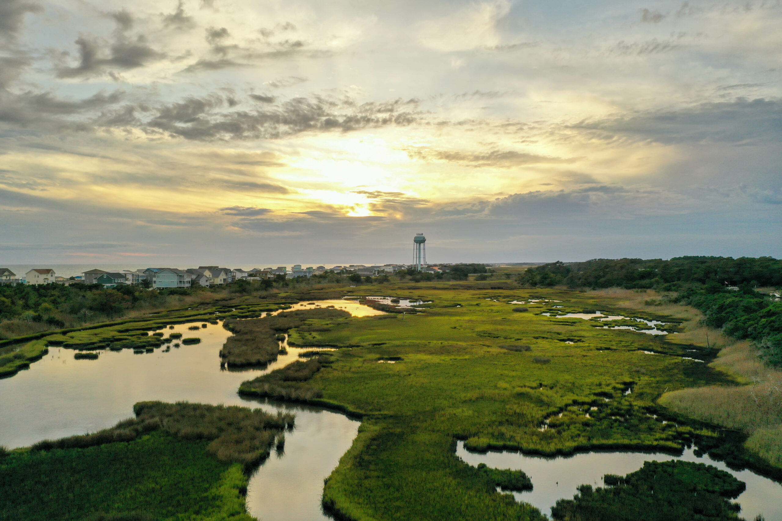 image: aerial view of marsh and seashore.