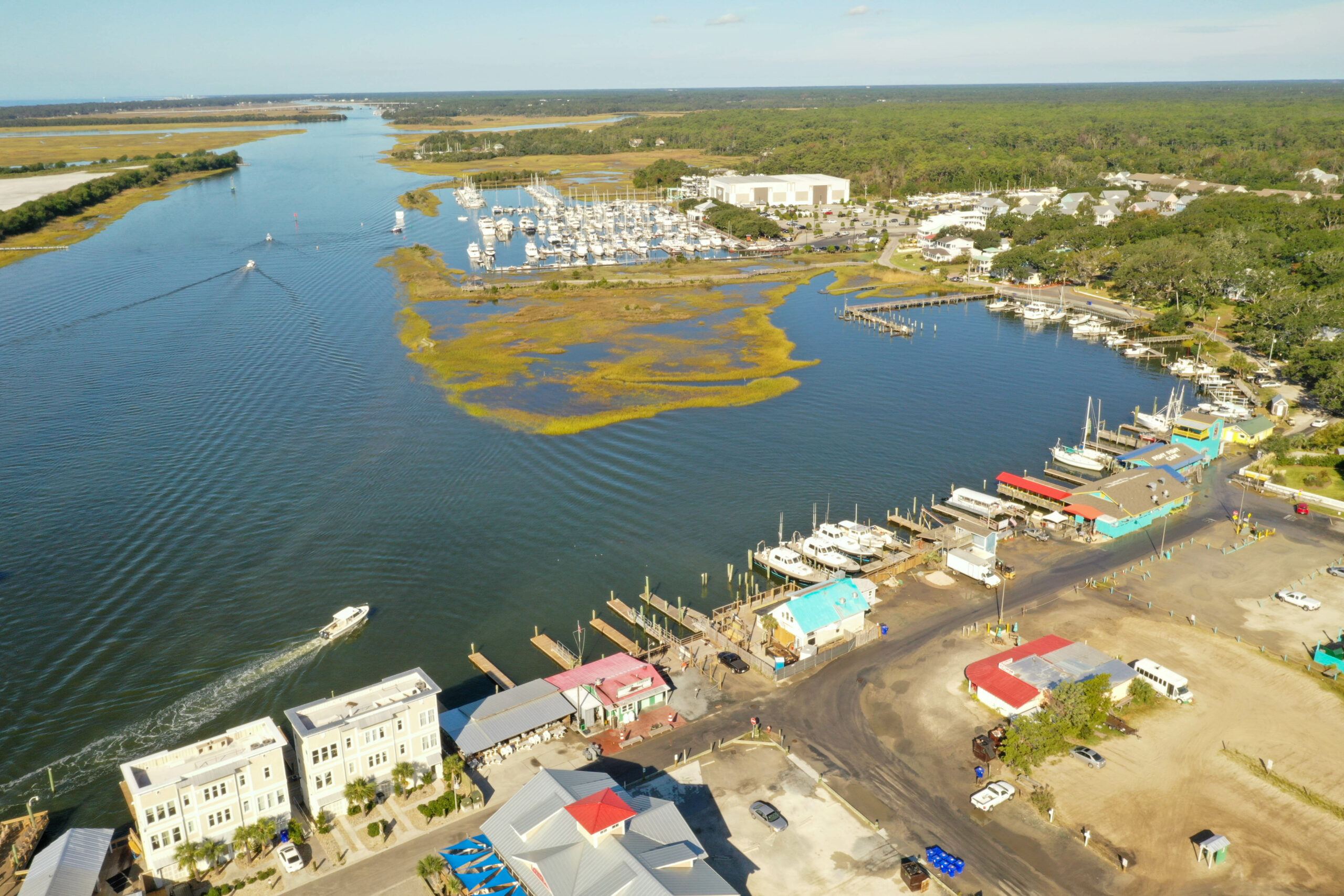 image: aerial view of waterfront marina in Southport, NC.