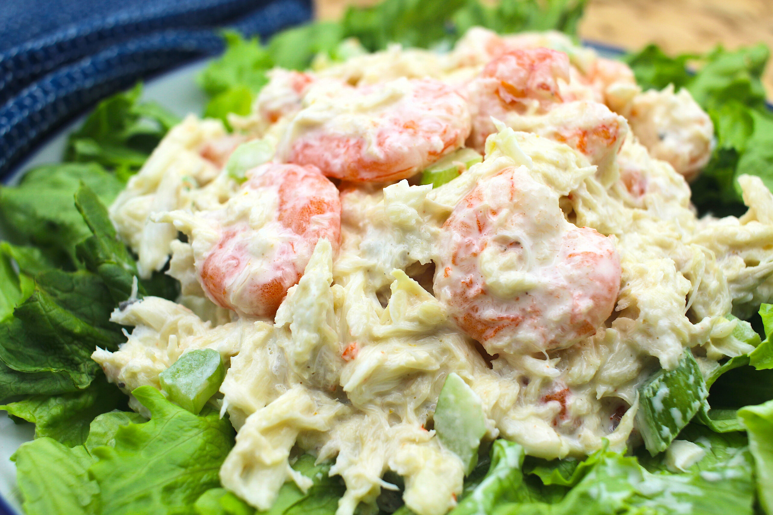 image: crab and shrimp salad on lettuce bed.