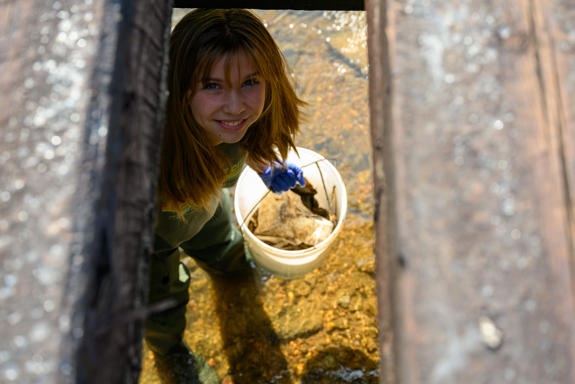 image: high school student collecting trash.