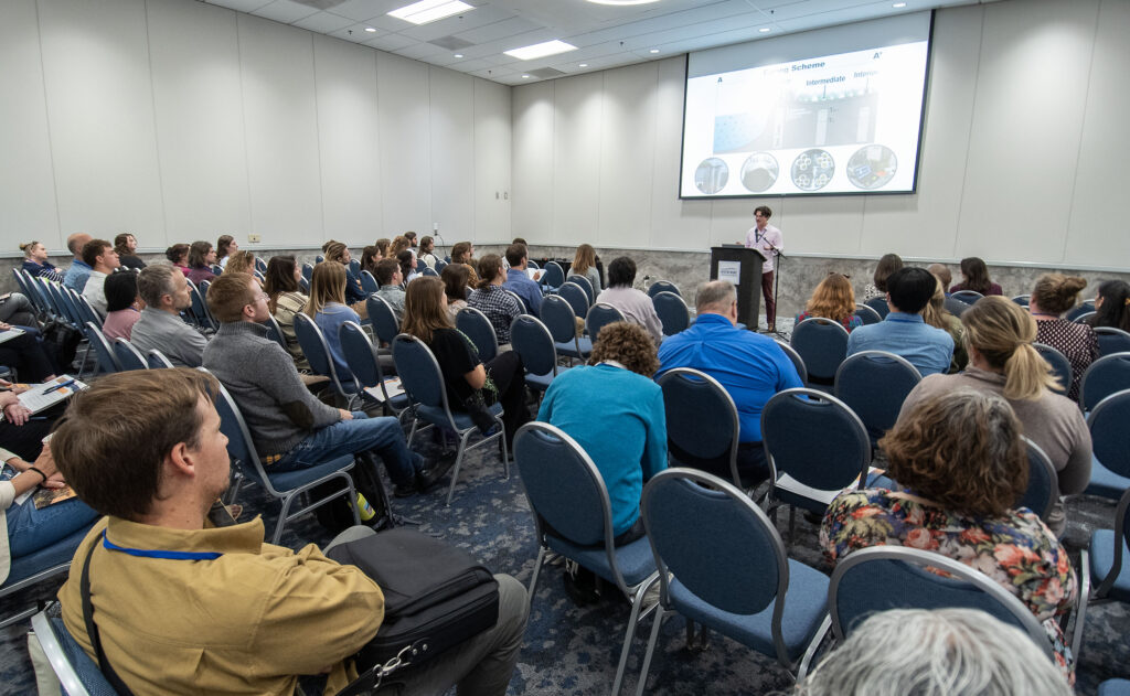 image: Joshua Himmelstein of UNC, talks about the role of nature levees in salt marshes during the afternoon research presentations at the 2024 North Carolina Coastal Conference. 