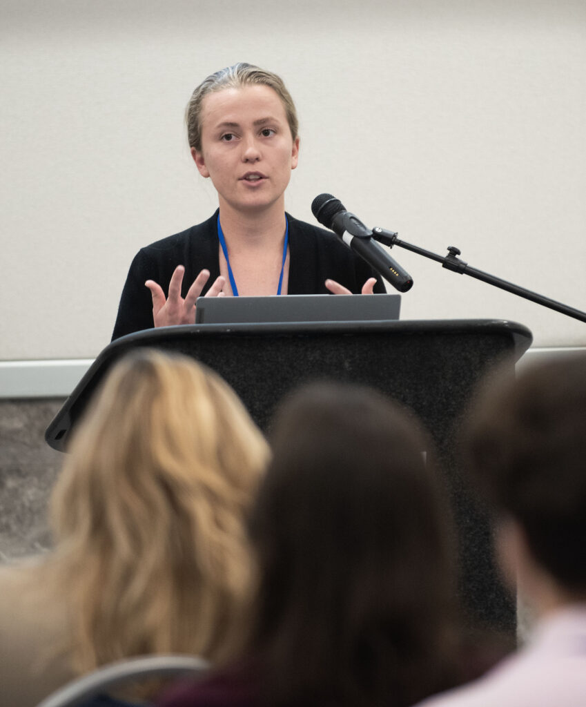 image: Grace Loonam, ECU, taks about oyster reef restoration during the afternoon research presentations at the 2024 North Carolina Coastal Conference. 