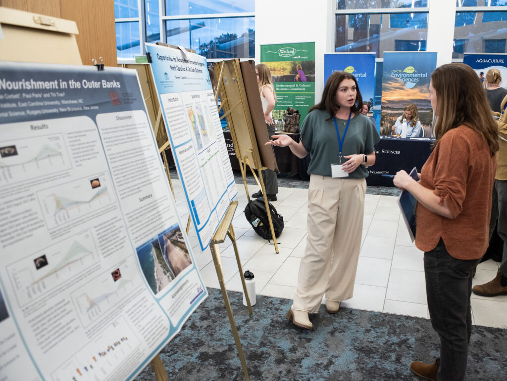 Demitra Sperelakis, UNC Wilmington, explains her research project during poster presentations at the 2024 North Carolina Coastal Conference. The event, hosted by North Carolina Sea Grant, was held Nov. 13-14, 2024 at the Riverfront Convention Center in New Bern, N.C. (Photo by Jamie Moncrief).