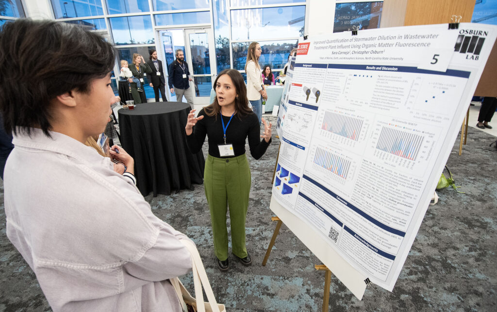 image: Sara Cornejo explains her research project during Day 1 poster presentations.