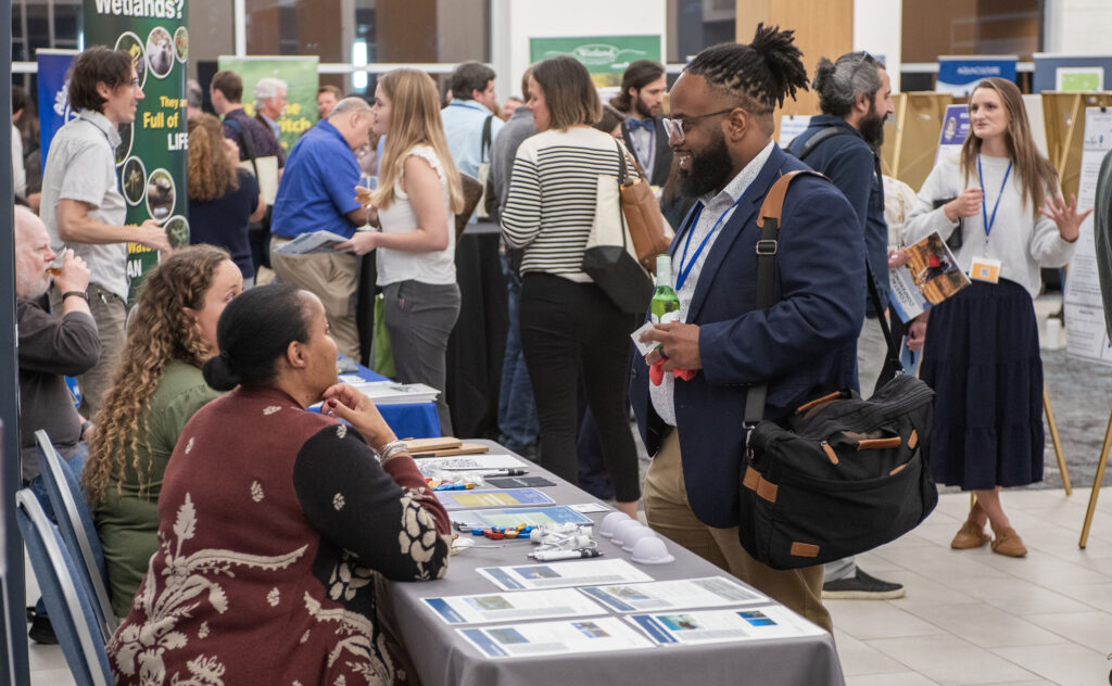 image: Vendors on display during the student poster presentations at the 2024 North Carolina Coastal Conference. The event, hosted by North Carolina Sea Grant, was held Nov. 13-14, 2024 at the Riverfront Convention Center in New Bern, N.C.