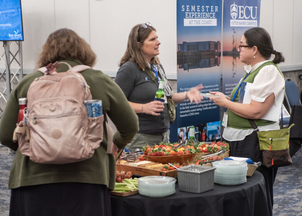 image: Conference participants mingle.