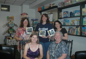 Manteo High School science teachers Joanne Miller, Lisa Serfling and Pat Holland show off their new books with Kathleen Angione and Terri Kirby Hathaway.