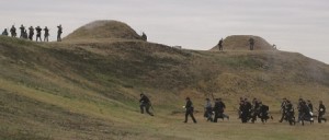 Civil war reenactment takes place on a hill.