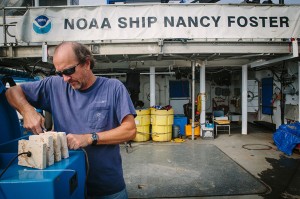 Steve Ross prepares benthic landers on the deck of the NOAA ship Nancy Foster.