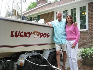 Jess and Diane Hawkins next to their boat, Lucky Dog.