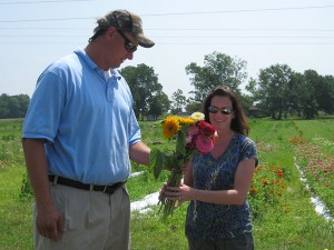 Ben Davis hands flower to customer Resha Ryan.