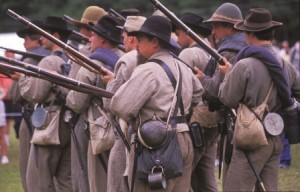 Volunteers perform a Civil War reenactment.