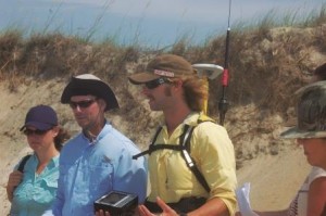 Chris Freeman (middle) and Ben Sumners (right) explain how GPS is used to map a beach's morphological features. 