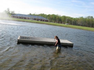 Doll measures the pond as part of the planning process. 