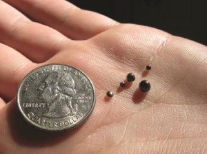 Tiny natural pearls placed next to a quarter for size. 