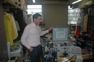 Researcher in lab with water monitoring equipment.