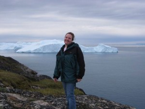 Jessica Maher stands in front of ice in Greenland.