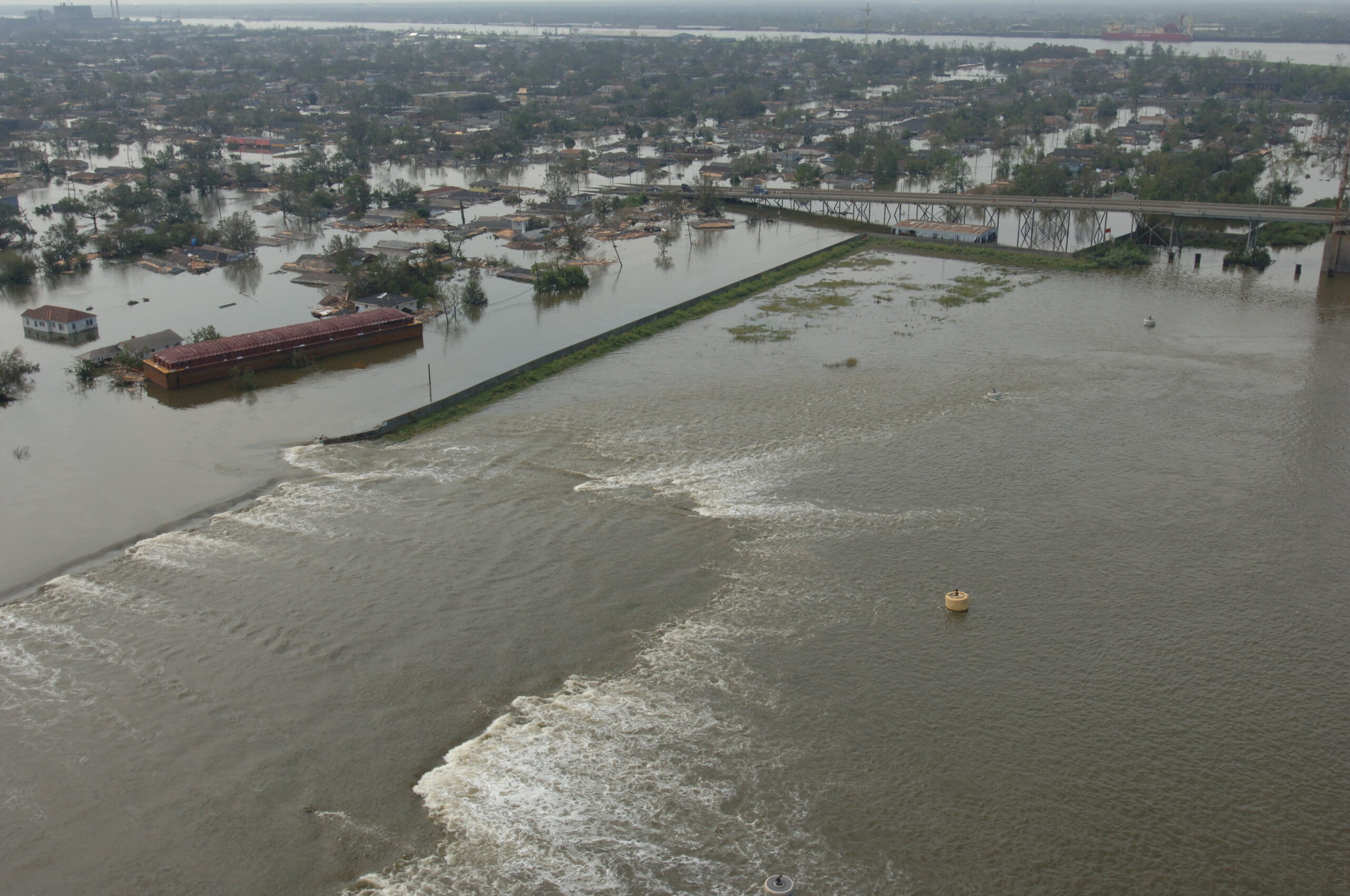Flood control solutions protect lives and property, but if such measures fail, the results can be catastrophic — like when this levee burst in New Orleans after Katrina. Credit: FEMA.