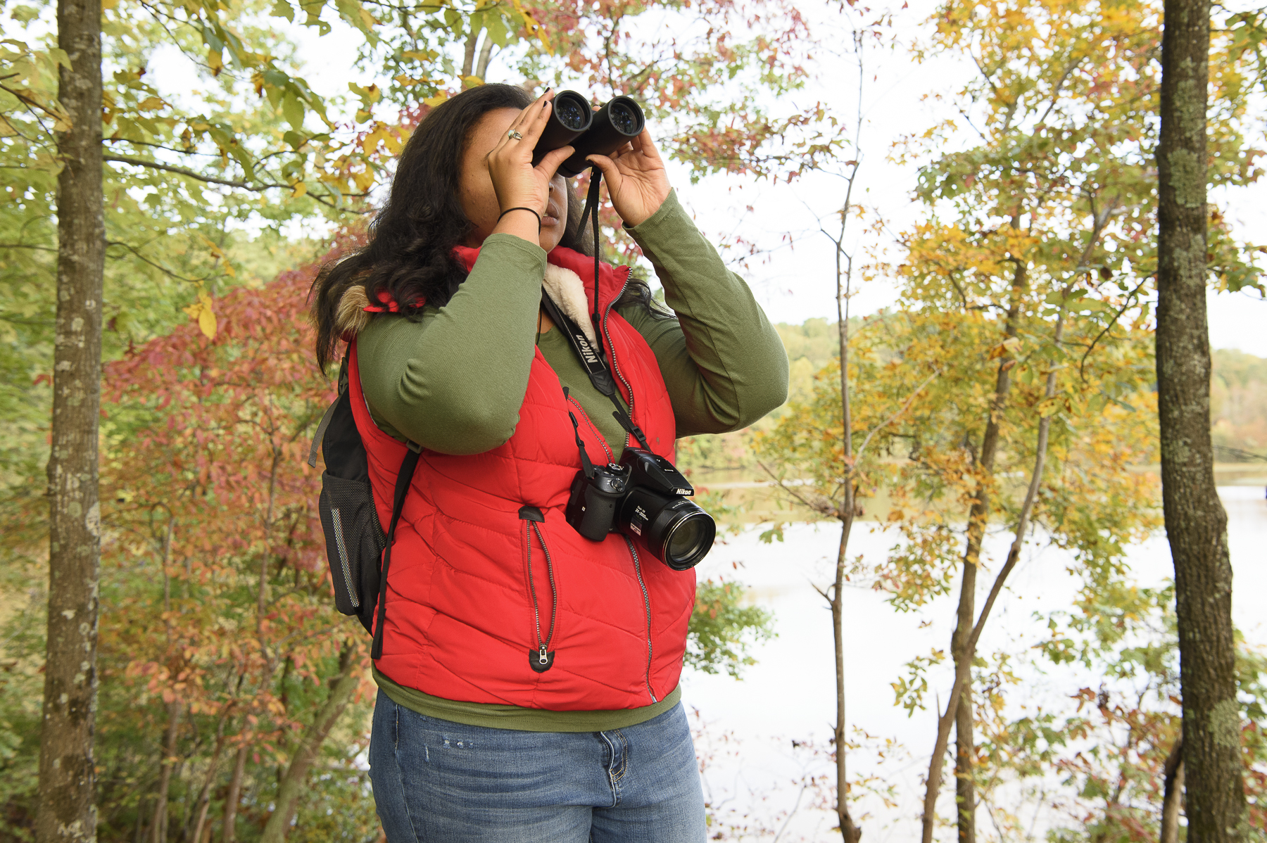 image: Lauren D. Pharr birdwatches on the trails around Lake Johnson. Credit: Melissa McGaw/NCWRC.