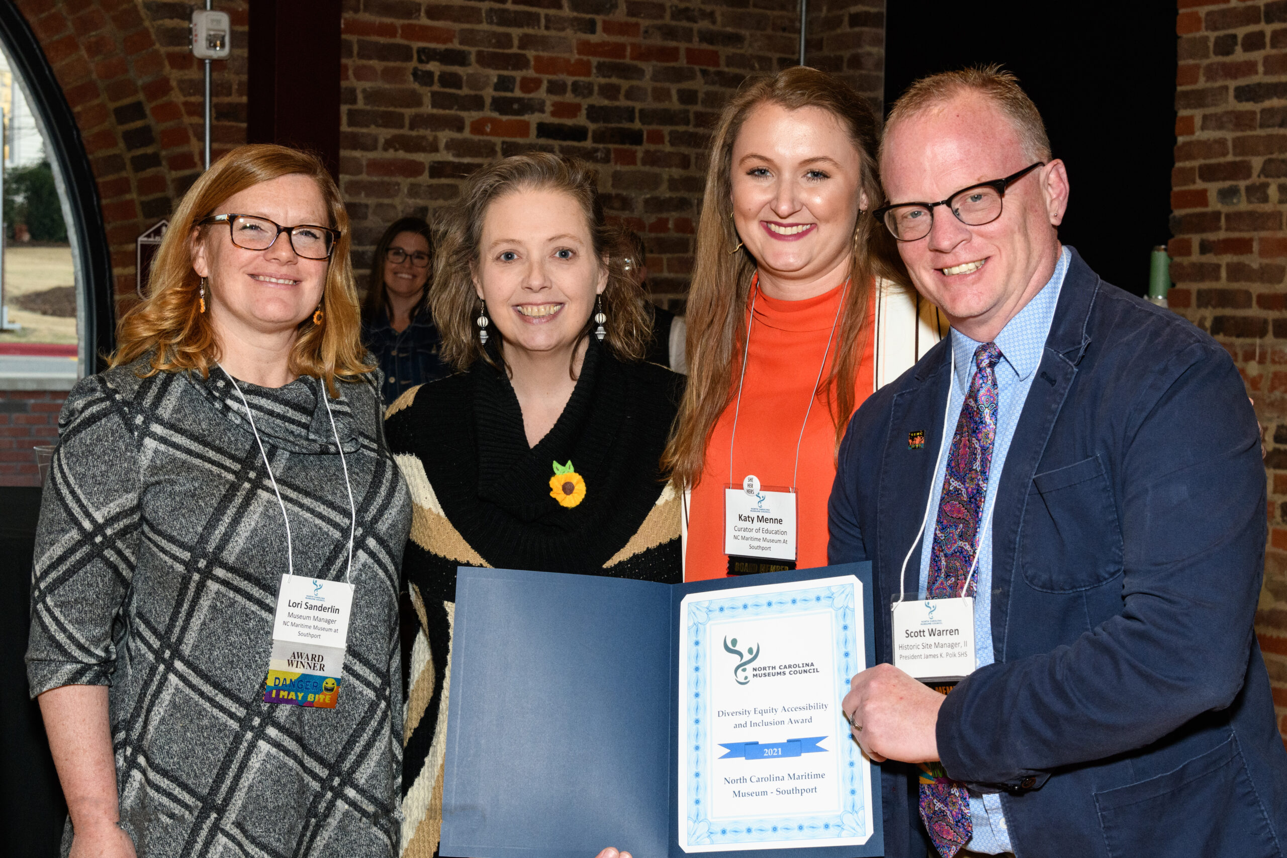 Lori Sanderlin (left) and Katy Menne (second from right) receive the Maritime Museum’s award from Council awards chair LeRae Umfleet and former president Scott Warren.