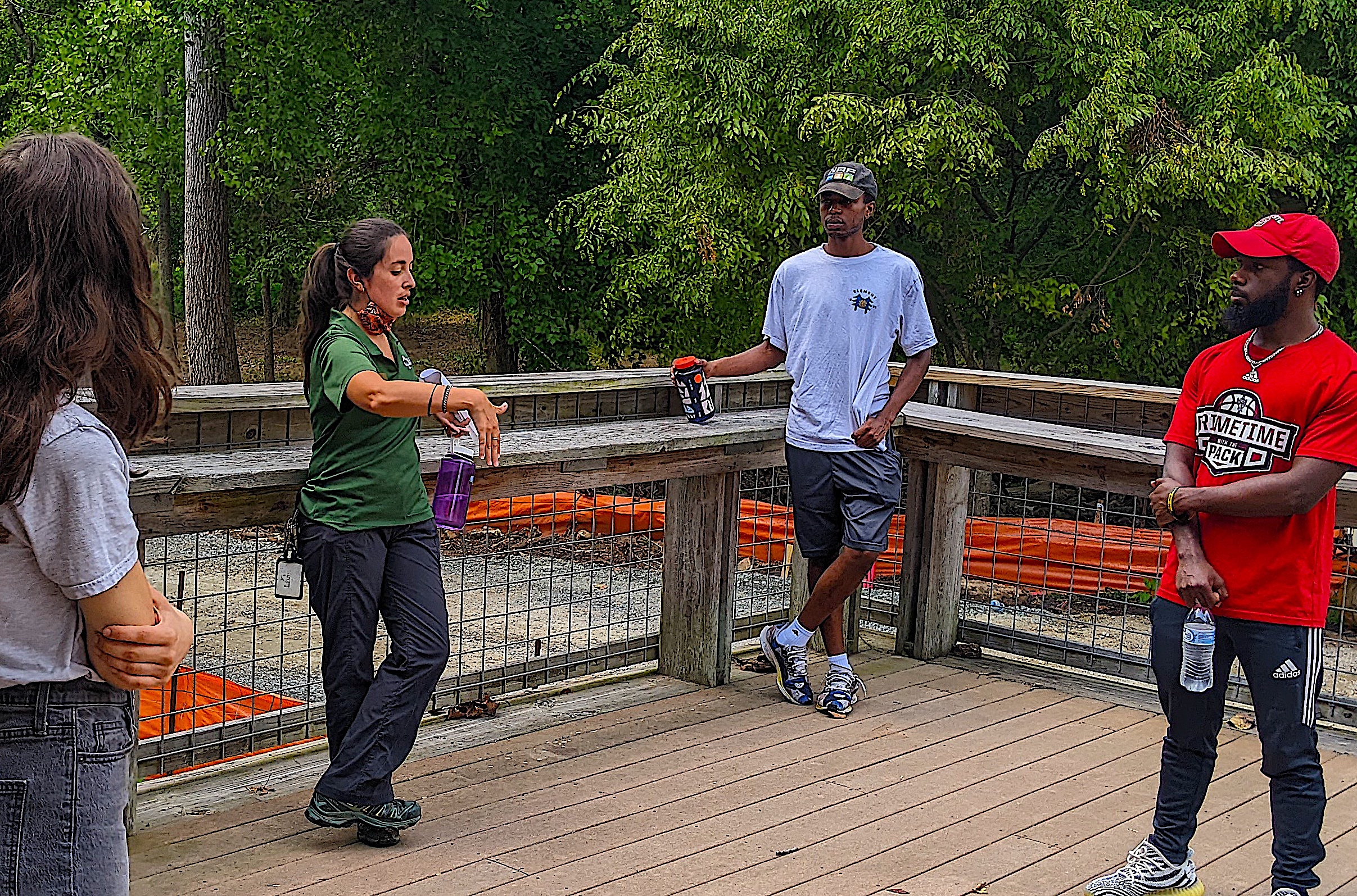 image: Youth conservation job training participants learn about environmental research opportunities from Liani Yirka (above), assistant director of Walnut Creek Wetland Park. Credit: Christy Perrin.