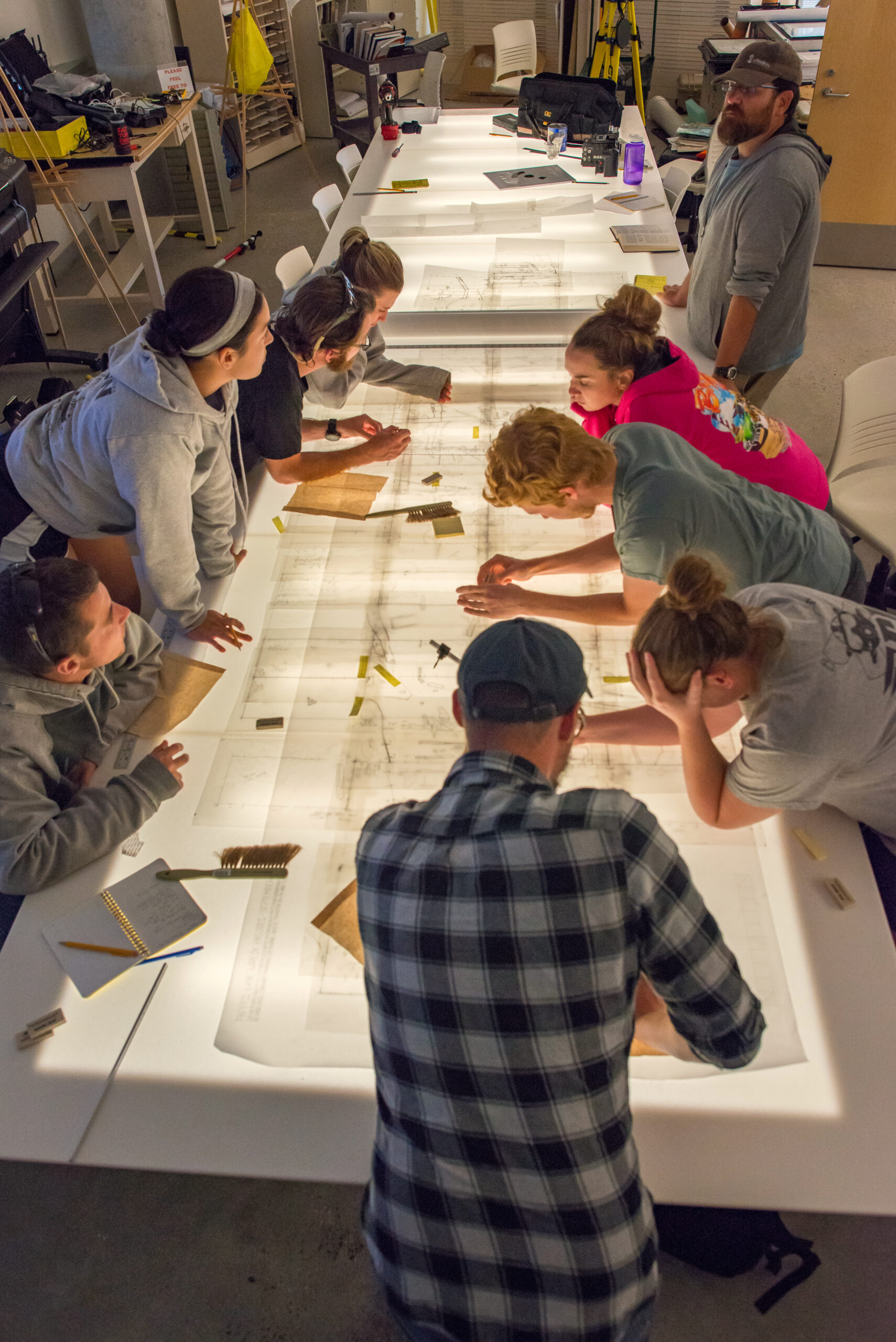 image: Nathan Richards (upper right) and his team stitched together and transposed 177 drawings onto a site map with a scale of 1 foot of theship to every 1 inch on the map. 