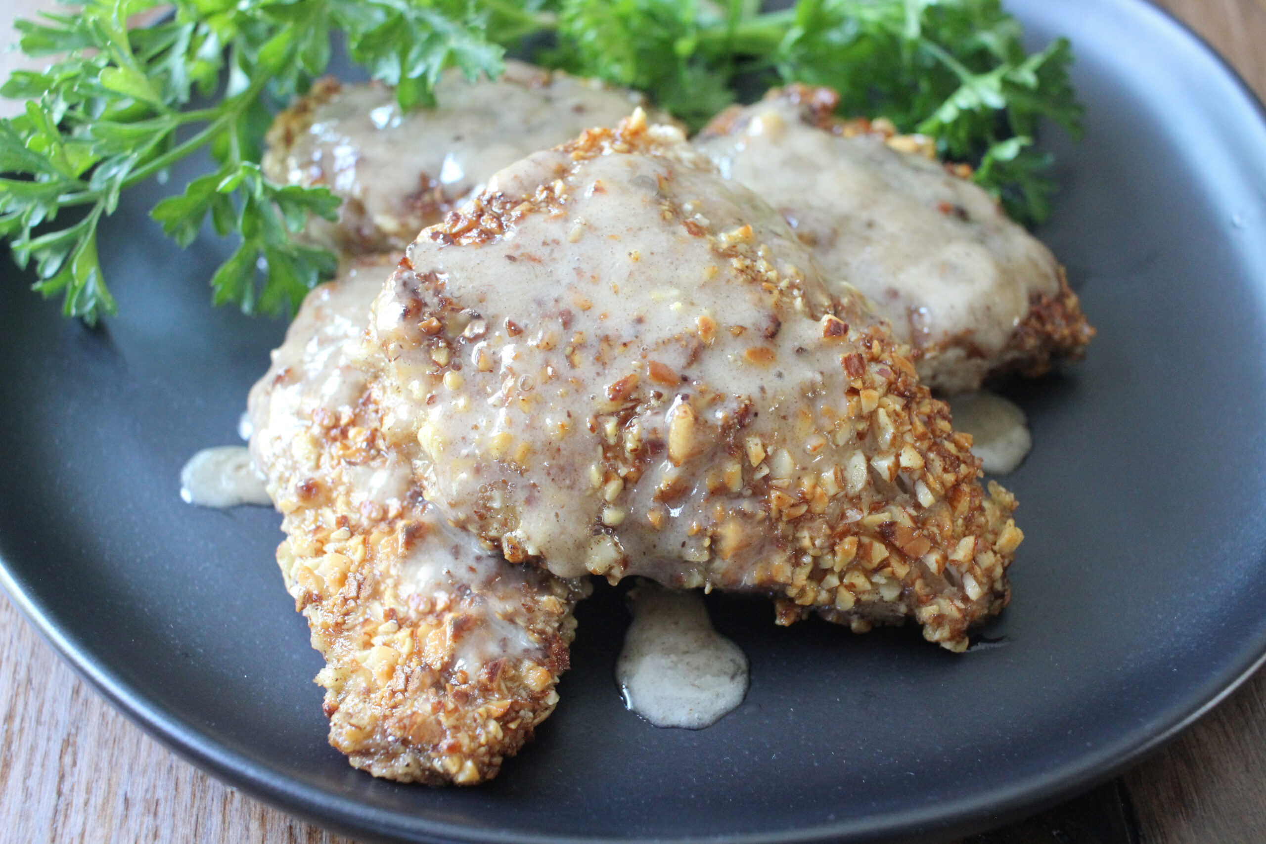 image: Almond-Encrusted Snapper on a plate with Cream Sauce.