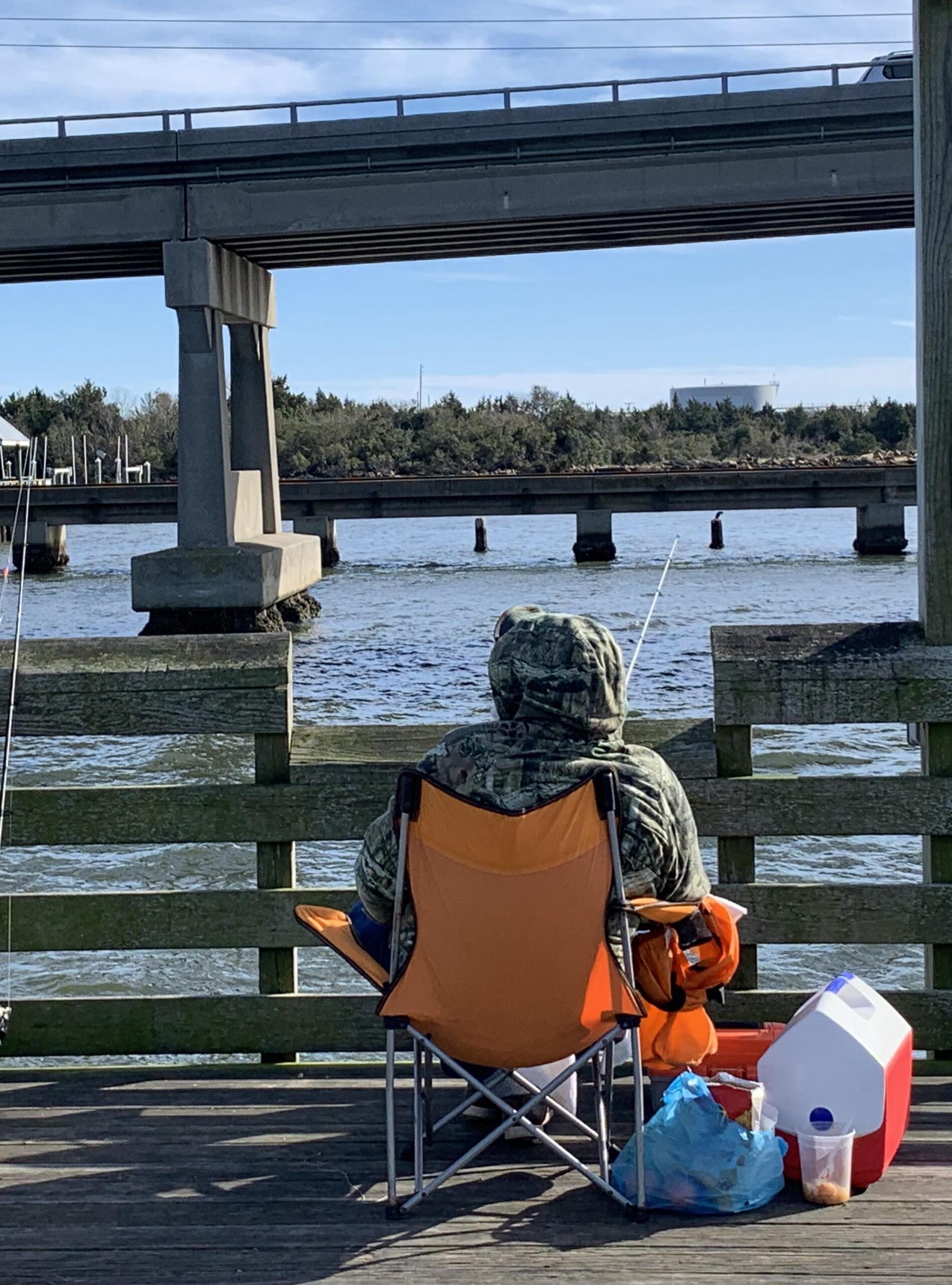 A fisherman settles in for a day of fishing at the Newport River Pier in Carteret County, NC.