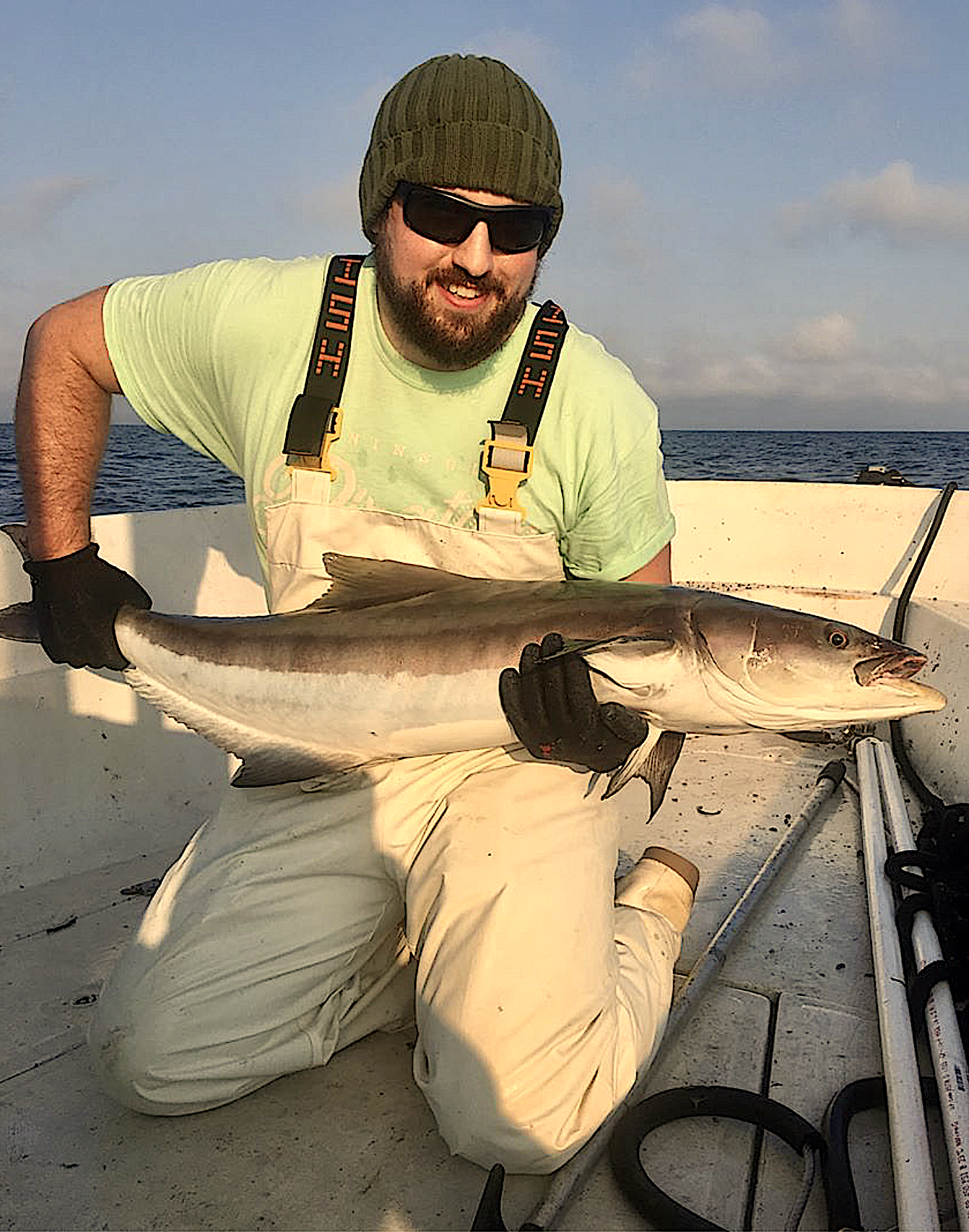 image: Damiano with an Atlantic cobia fish. Credit: NC State CALS News.