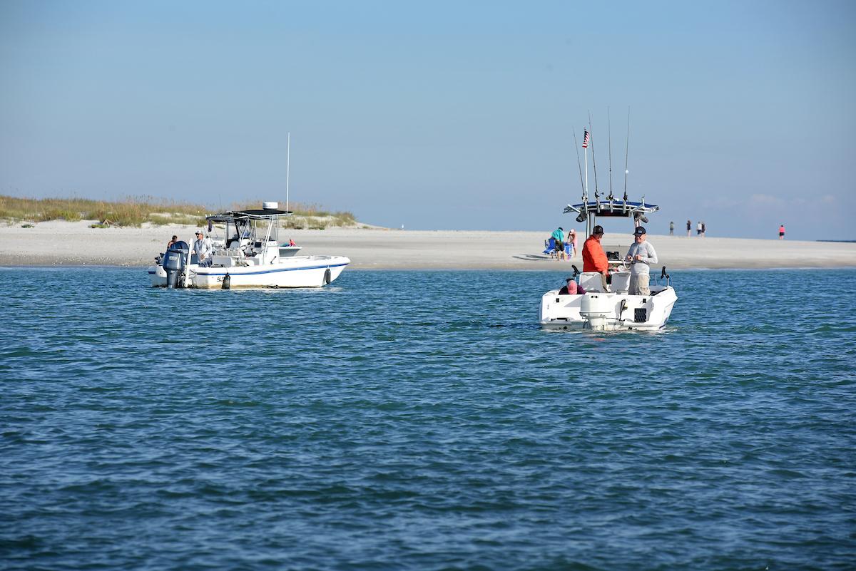 Fishermen drift through Mason Inlet