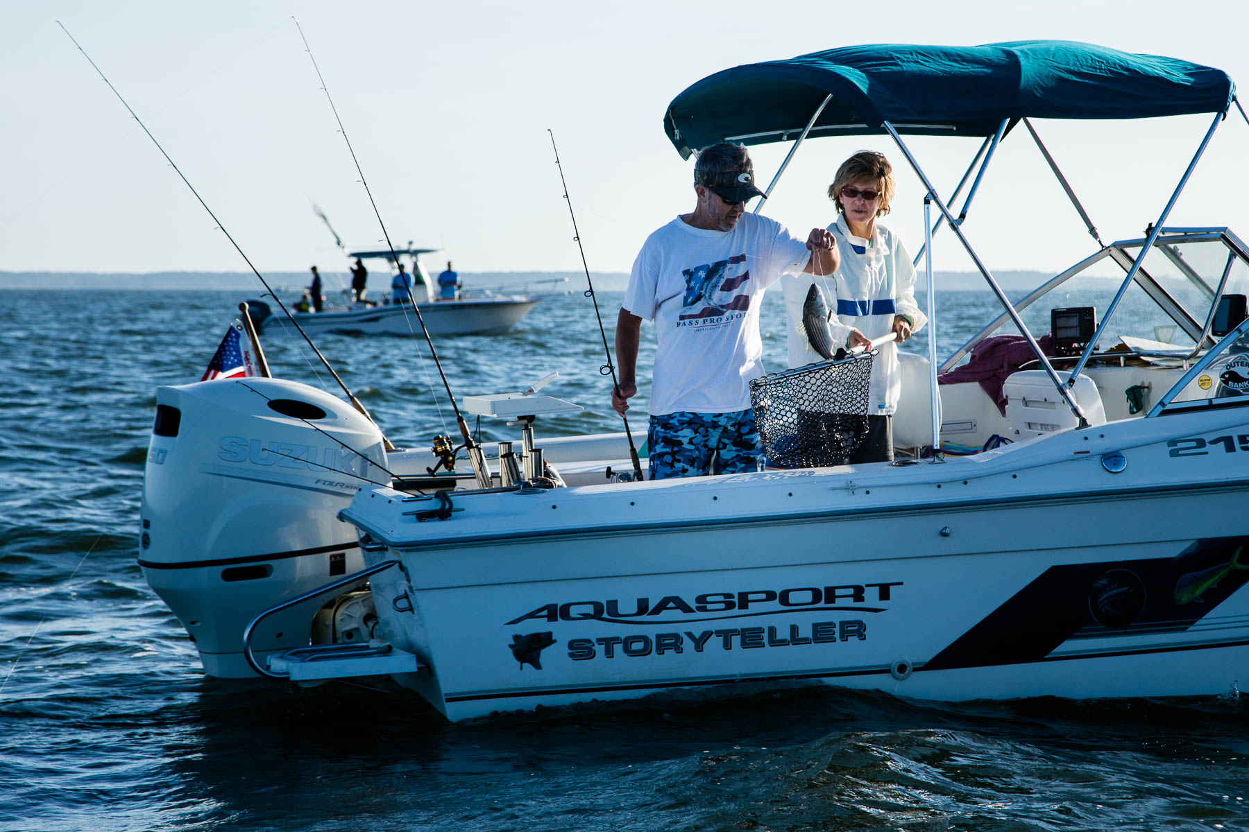 image: Herb Floyd and his wife Rhonda Floyd of Trappe, Md., pull up a striped bass at Cook's Point oyster reef during the Rod and Reef Slam fishing tournament on the Choptank River on Oct. 7, 2017. The tournament was hosted by the Chesapeake Bay Foundation to highlight the return of trophy fish species that rely on oyster reef habitat in Chesapeake Bay. Cook's Point is a site where CBF has installed reef balls to spur oyster recovery, and other partners that restored reefs featured in the tournament include NOAA, Coastal Conservation Association, and Maryland Department of Natural Resources. (Photo by Will Parson/Chesapeake Bay Program).