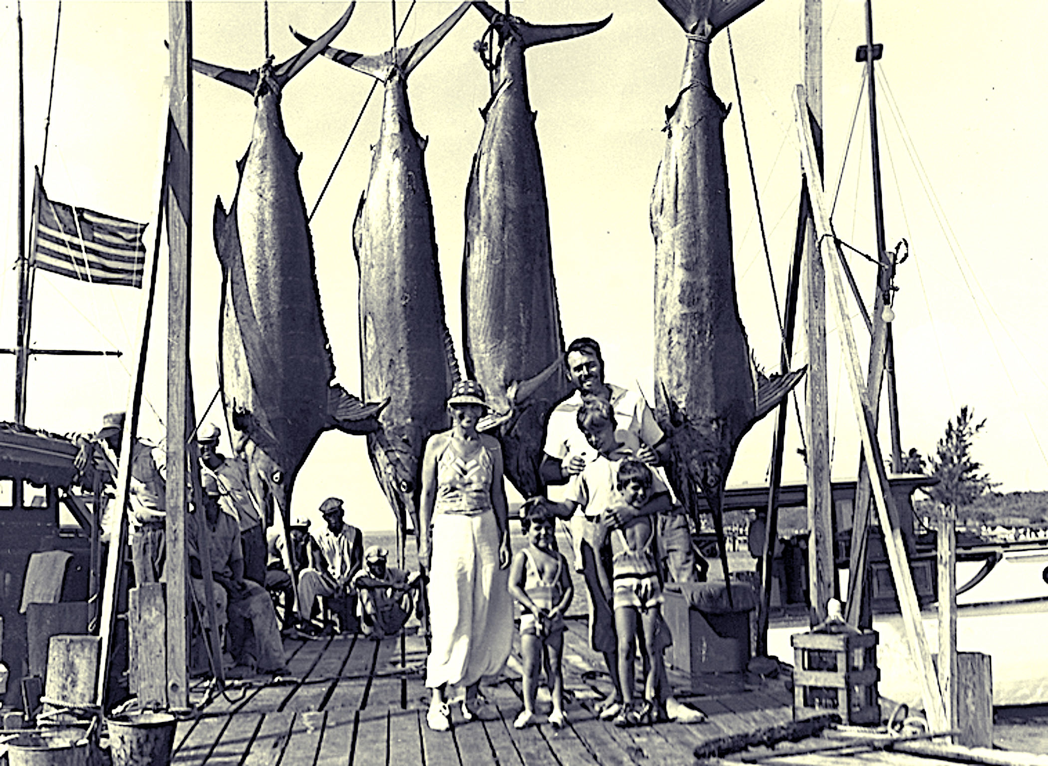 image: author Ernest Hemingway with Pauline, Gregory, John, and Patrick Hemingway and four marlins on the dock in Bimini, 20 July 1935.