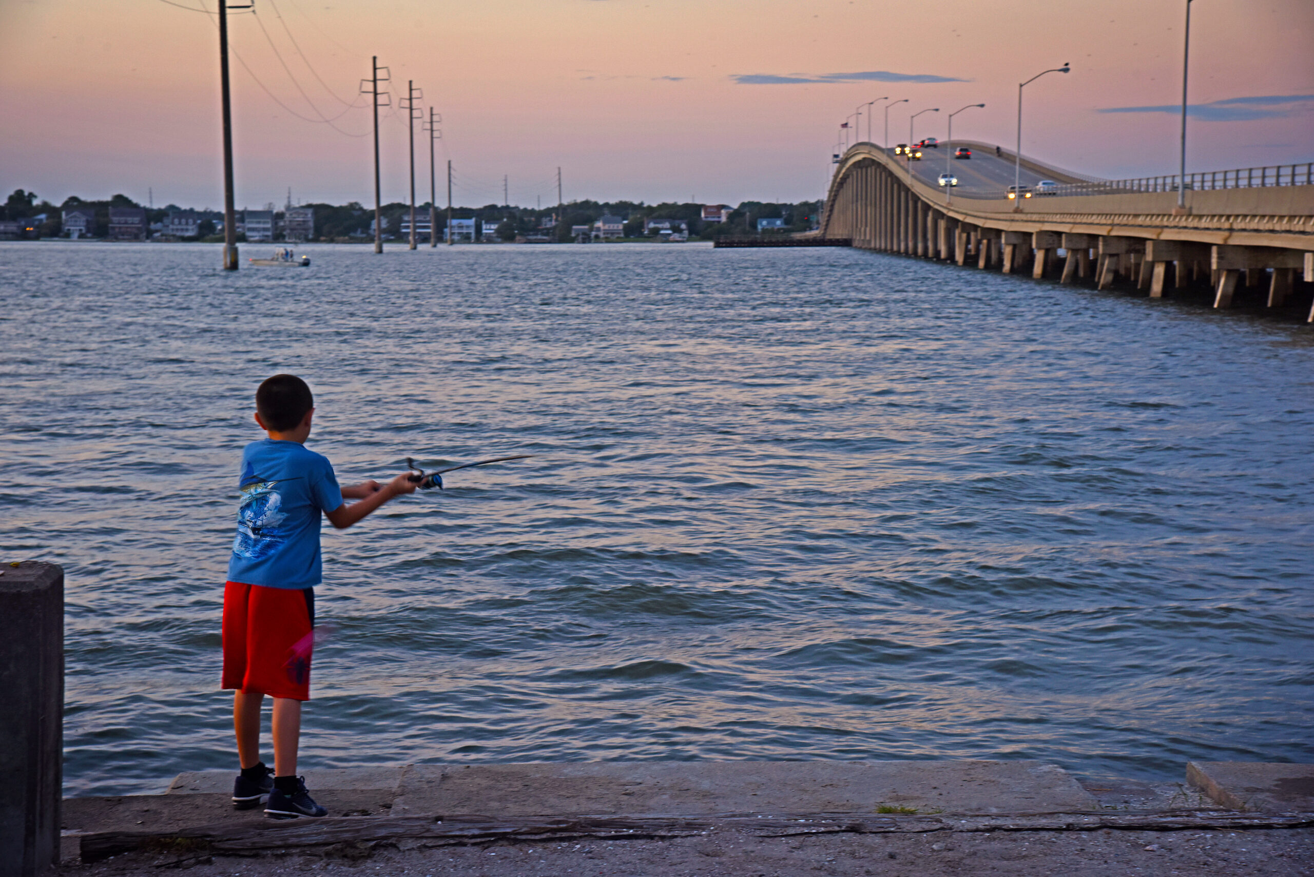 image: boy fishing.