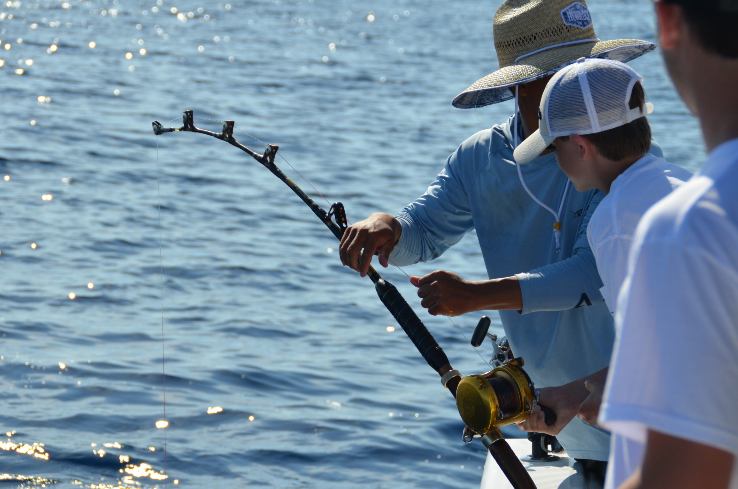 image: anglers fishing on boat.