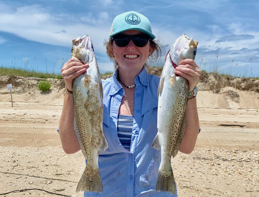 image: Johnna Brooks holding a pair of spotted seatrout.