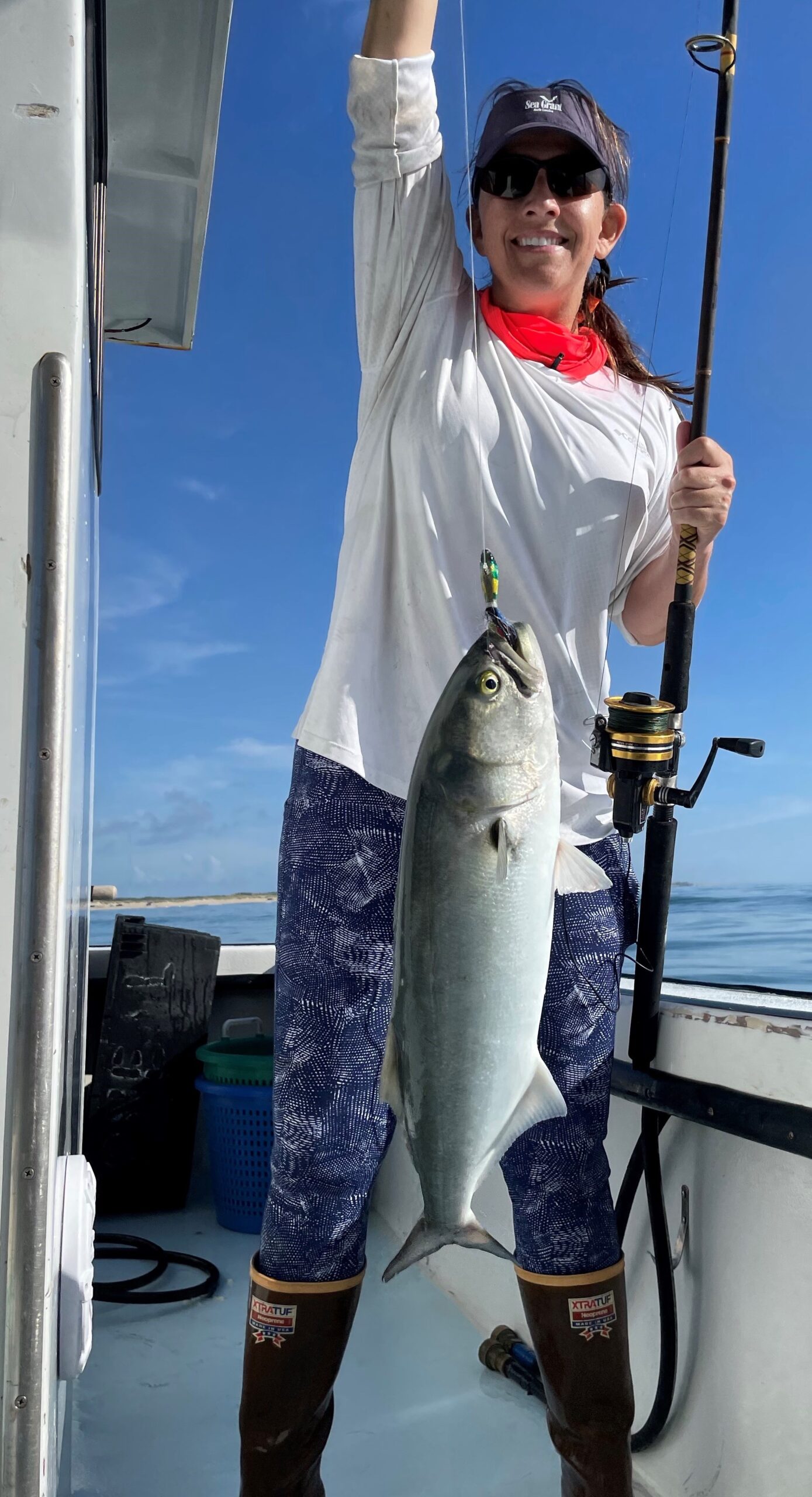 image: The author and her catch (bluefish).
