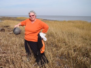 Terri Kirby Hathaway with a bowling ball she found beachcombing.