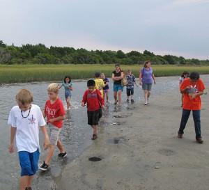 Students wading in water at Rachel Carson Reserve.