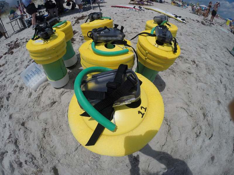 Data-logging drifters with yellow tops, green bodies and tubing, and GPS devices.
