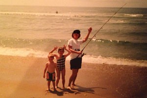 Boy, girl and father with fishing pole at beach