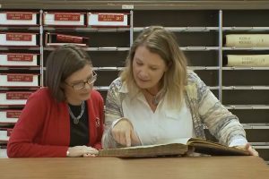 Two women looking at a book