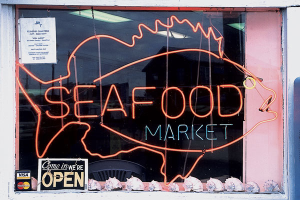 Seafood market sign in the shape of a fish