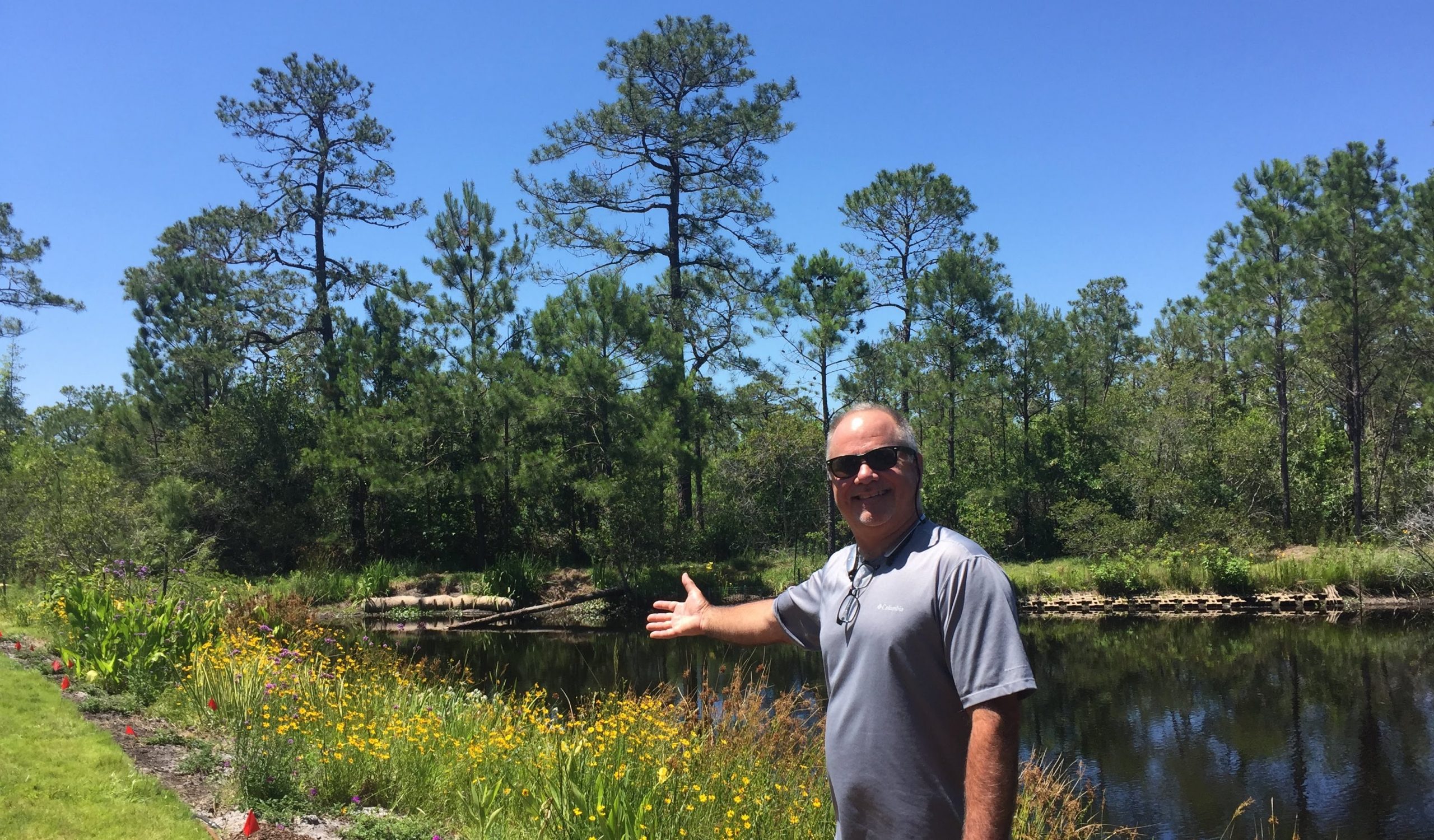 Wilmington homeowner in front of stormwater pond_by Jane Harrison