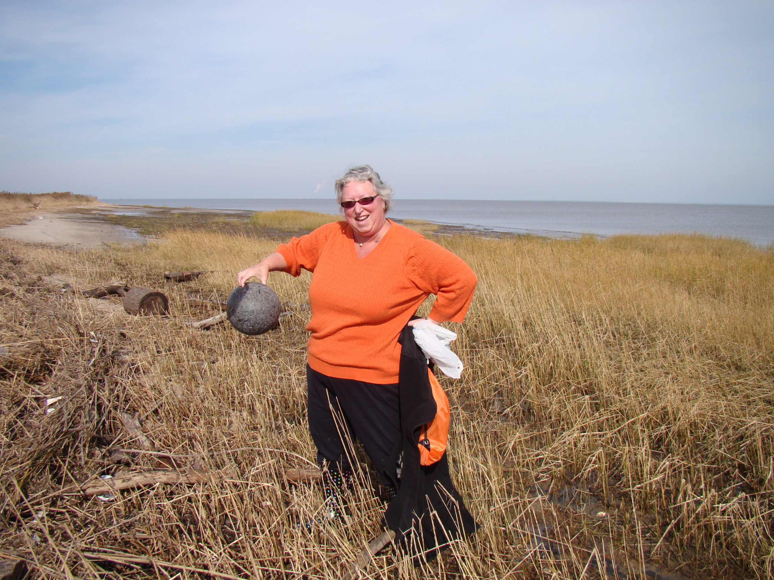 Terri Kirby Hathway marvels over a beachcombed bowling ball.